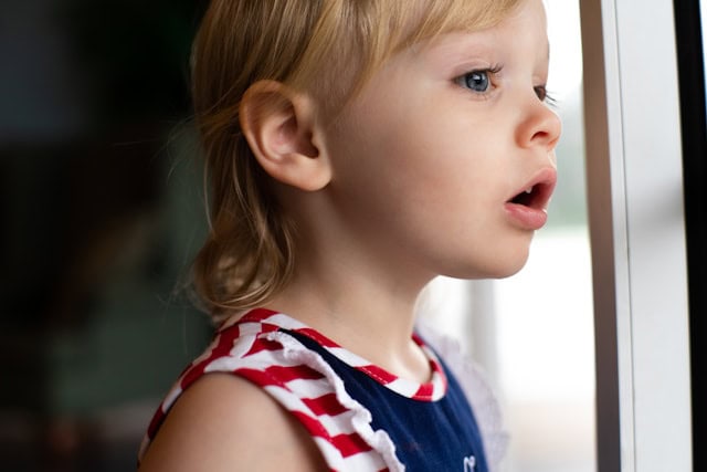 Young child looking out of a window