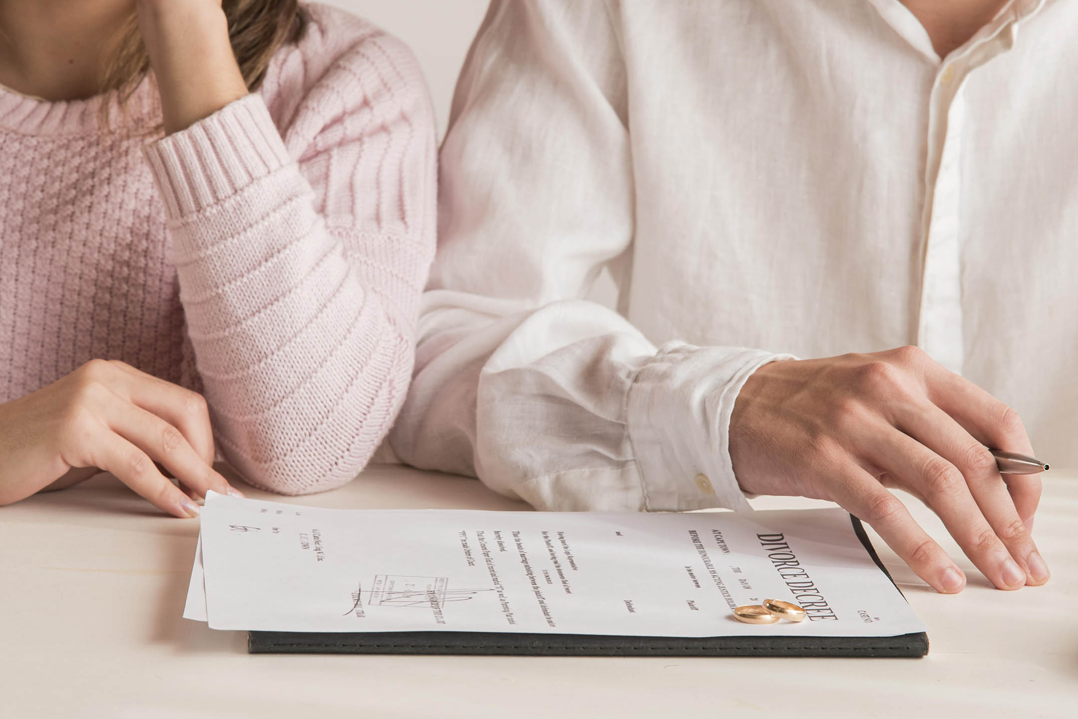 Divorcing couple overlooking divorce decree
